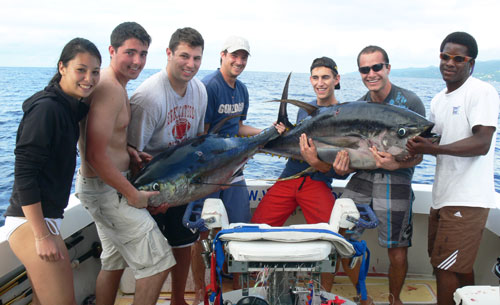students with 2 big yellowfin tuna they caught on an epic trip!
