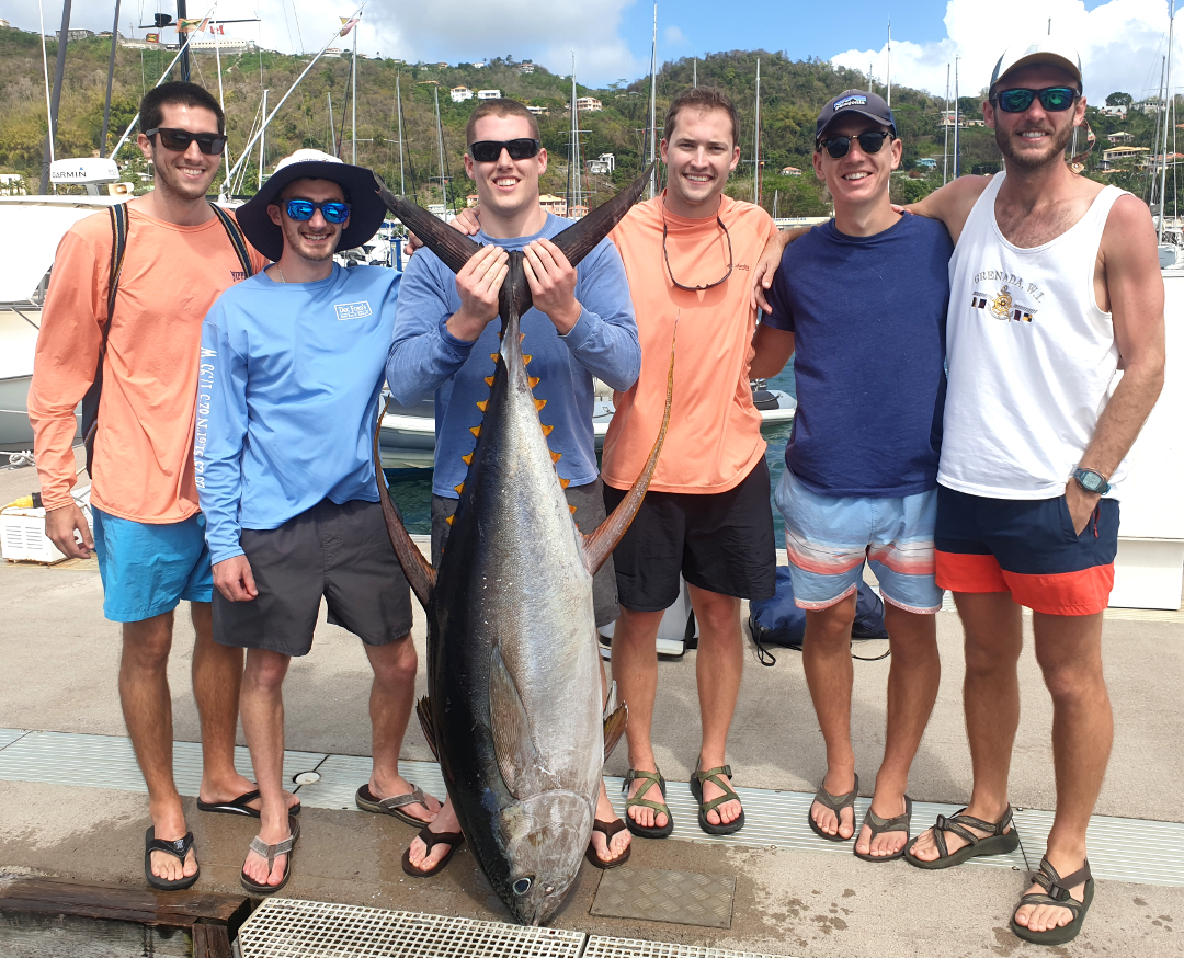 students with a big yellowfin tuna they caught